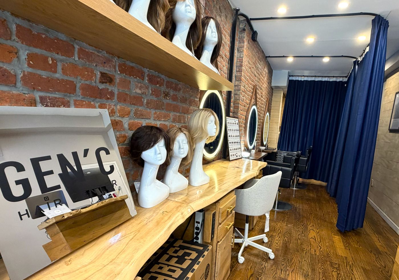 Gen'C Hair Center Chelsea salon interior, showing GEN'C branding, wig display and styling area